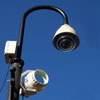 Photograph of a security camera mounted on a lamppost